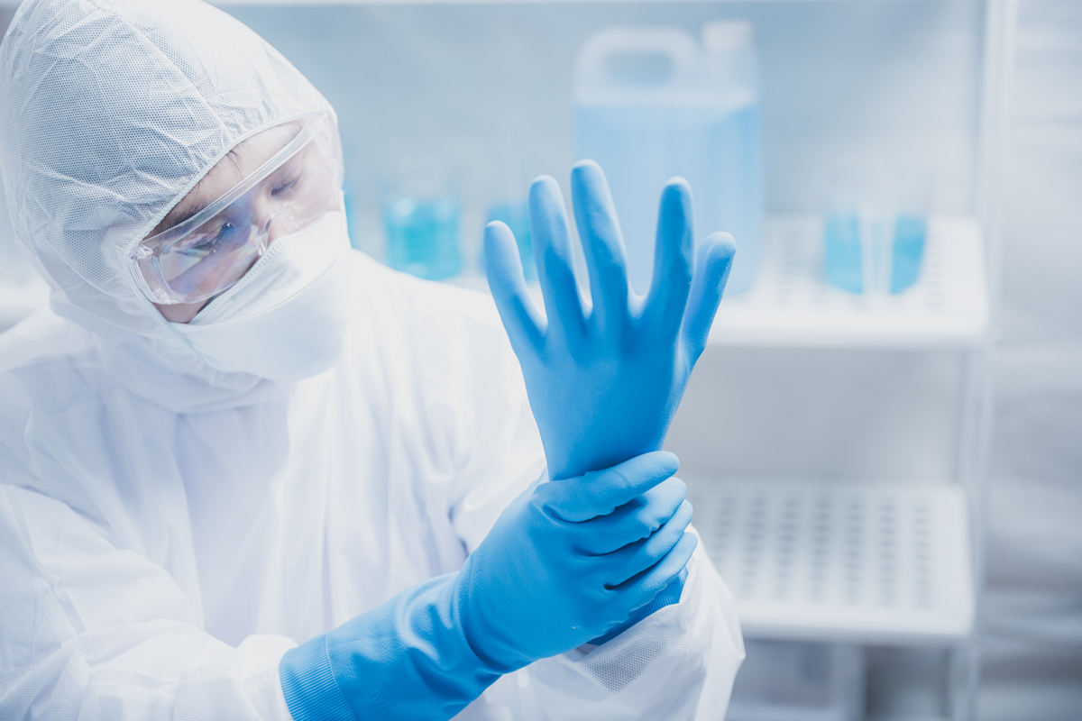 Lab tech putting on safety equipment